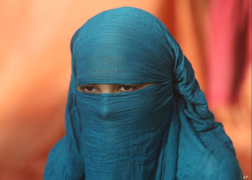 Fourteen-year-old Neha sits during an interview Nov. 11, 2020, in Karachi, Pakistan. Neha's family forced her to marry a 45-year-old Muslim man, who first made her convert from Christianity to Islam. (AP Photo)